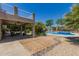 Expansive backyard patio with outdoor seating, lush landscaping, and a sparkling swimming pool at 4648 W Misty Willow Ln, Glendale, AZ 85310