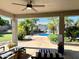 Covered patio overlooking a sparkling pool and landscaped backyard, ideal for outdoor living at 4648 W Misty Willow Ln, Glendale, AZ 85310