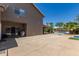 Spacious backyard with concrete patio, lush greenery, and a glimpse of the pool and gazebo at 4648 W Misty Willow Ln, Glendale, AZ 85310