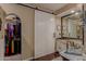 Bathroom featuring barn door access leading into the closet and double sinks at 4648 W Misty Willow Ln, Glendale, AZ 85310