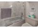 Modern tiled shower with a glass door, tissue holder and toilet at 4648 W Misty Willow Ln, Glendale, AZ 85310
