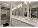 Bathroom featuring a large mirror, shower, and vanity with double sinks at 4648 W Misty Willow Ln, Glendale, AZ 85310