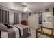 Cozy bedroom with a ceiling fan, closet, and adjacent bathroom at 4648 W Misty Willow Ln, Glendale, AZ 85310