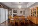 Elegant dining room boasts hardwood floors, chandelier, and large wooden table with seating for six at 4648 W Misty Willow Ln, Glendale, AZ 85310
