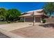 Spacious home featuring a three-car garage, basketball hoop, and well-maintained landscaping at 4648 W Misty Willow Ln, Glendale, AZ 85310