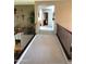 Open hallway with neutral carpet, iron railings, and views to a dining room at 4648 W Misty Willow Ln, Glendale, AZ 85310
