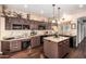 Stylish kitchen featuring granite countertops, brown cabinets, and stainless steel appliances at 4648 W Misty Willow Ln, Glendale, AZ 85310