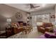 Inviting living room with comfortable seating, ceiling fan, and sliding glass door to the outside at 4648 W Misty Willow Ln, Glendale, AZ 85310