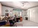 A spacious office with a ceiling fan, closet, and ample space for multiple desks at 4648 W Misty Willow Ln, Glendale, AZ 85310