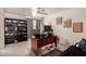 Bright home office with shelves, a desk, and a comfortable chair at 4648 W Misty Willow Ln, Glendale, AZ 85310