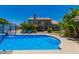 Inviting backyard pool with steps and mature landscaping, perfect for relaxing and entertaining at 4648 W Misty Willow Ln, Glendale, AZ 85310