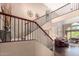 Elegant staircase with dark wood trim and an open view of the spacious living area at 4648 W Misty Willow Ln, Glendale, AZ 85310