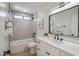 Bright bathroom featuring a shower-over-tub, modern vanity with black hardware, and neutral tiled walls at 4725 E Brown Rd # 13, Mesa, AZ 85205