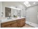 Modern bathroom with double vanity, skylight, sleek fixtures, and a frameless glass shower for a luxurious feel at 4725 E Brown Rd # 13, Mesa, AZ 85205