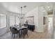 Elegant dining room with modern chandelier, sleek furniture, and light-filled with a large window at 4725 E Brown Rd # 13, Mesa, AZ 85205