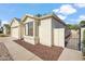Side view of a well-kept home with a neutral stucco exterior, large window, and tidy desert landscaping at 4725 E Brown Rd # 13, Mesa, AZ 85205