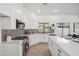 Modern kitchen with white cabinetry, stainless steel appliances, mosaic tile backsplash, and quartz countertops at 4725 E Brown Rd # 13, Mesa, AZ 85205