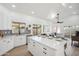 Bright, modern kitchen with white cabinets, island, stainless steel appliances, and decorative backsplash at 4725 E Brown Rd # 13, Mesa, AZ 85205