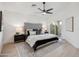 Serene main bedroom with a large bed, stylish decor, and sliding glass door to the backyard at 4725 E Brown Rd # 13, Mesa, AZ 85205