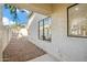 A covered back patio and yard with large windows looking into the home at 4725 E Brown Rd # 13, Mesa, AZ 85205