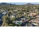 Expansive aerial view showcasing a backyard pool and neighborhood with mountain views in the distance at 5112 N 41St St, Phoenix, AZ 85018