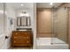 Bathroom vanity with granite countertop, tiled shower and glass enclosure at 5112 N 41St St, Phoenix, AZ 85018