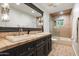 Bathroom with a black vanity, double sinks, large mirrors, and a tiled walk-in shower and tub at 5112 N 41St St, Phoenix, AZ 85018