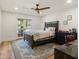Bedroom with hardwood floors, a ceiling fan, a blue rug and a desk at 5112 N 41St St, Phoenix, AZ 85018