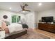 Cozy bedroom featuring neutral tones, a ceiling fan, and a large window providing plenty of natural light at 5112 N 41St St, Phoenix, AZ 85018