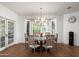 Bright dining room featuring a round table, brick floors, and ample natural light from the bay window at 5112 N 41St St, Phoenix, AZ 85018