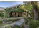 Charming covered front porch with a stone entryway and lush vines, creating a welcoming entrance at 5112 N 41St St, Phoenix, AZ 85018