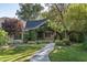 Charming front porch with a stone entryway and lush vines and foliage, and an American flag at 5112 N 41St St, Phoenix, AZ 85018
