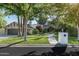 Charming single story home with mature trees, lush lawn, and unique stone and brick accents on a sunny day at 5112 N 41St St, Phoenix, AZ 85018