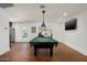 Spacious game room featuring a pool table, brick floors, recessed lights, and a large-screen television at 5112 N 41St St, Phoenix, AZ 85018