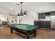 Entertaining game room featuring a billiards table, kitchenette, and an open layout with stylish lighting at 5112 N 41St St, Phoenix, AZ 85018