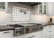 Close-up of a modern stovetop with a pot filler and subway tile backsplash, showcasing quality appliances at 5112 N 41St St, Phoenix, AZ 85018