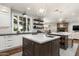 Modern kitchen with dual islands, white cabinets, open shelving, and brick flooring, flowing into the living space at 5112 N 41St St, Phoenix, AZ 85018