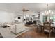 Open-concept living area with brick flooring, a ceiling fan, and seamless access to the kitchen and dining areas at 5112 N 41St St, Phoenix, AZ 85018