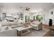 Bright living room featuring comfortable sofas, brick flooring, and open access to the kitchen and dining areas at 5112 N 41St St, Phoenix, AZ 85018