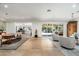 Spacious living room with wood floors, leading to a backyard view and adjoining dining and office spaces at 5112 N 41St St, Phoenix, AZ 85018