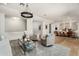 Open-concept living room with stylish seating, light wood floors, and a seamless flow into the dining area at 5112 N 41St St, Phoenix, AZ 85018