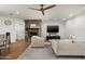 Cozy living room with a stone fireplace, mounted TV, and plush seating arrangement on the patterned rug at 5112 N 41St St, Phoenix, AZ 85018