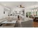 Open-concept living area with brick flooring, a ceiling fan, and seamless access to the kitchen and dining areas at 5112 N 41St St, Phoenix, AZ 85018