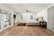 Bright primary bedroom features a ceiling fan, hardwood floors, and patio access to outdoor views at 5112 N 41St St, Phoenix, AZ 85018