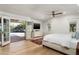 Bright primary bedroom boasts patio access, hardwood floors, ceiling fan, and serene backyard views at 5112 N 41St St, Phoenix, AZ 85018