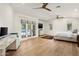 Spacious bedroom with hardwood floors, a ceiling fan, a desk and patio access at 5112 N 41St St, Phoenix, AZ 85018