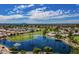 Scenic aerial view of community with a lake, fountain, golf course, and residential area at 520 S Sand Verbena Way, Mesa, AZ 85208