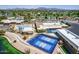Community aerial view featuring a pool, pickleball courts, recreation center, and nearby lake at 520 S Sand Verbena Way, Mesa, AZ 85208