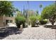 Well-maintained backyard with desert landscaping, grass and patio furniture at 520 S Sand Verbena Way, Mesa, AZ 85208