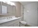 Bright bathroom with white vanity, framed mirror, and tiled walk-in shower at 520 S Sand Verbena Way, Mesa, AZ 85208